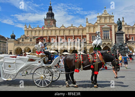 Krakow, Poland - July 8th 2018. A horse driven carriage awaits tourists in Rynek Glowny, the historic central square in old town Krakow Stock Photo