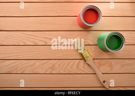 Two cans of paint for wood and brush on wooden slats. Home diy concept. Top view. Horizontal composition. Stock Photo