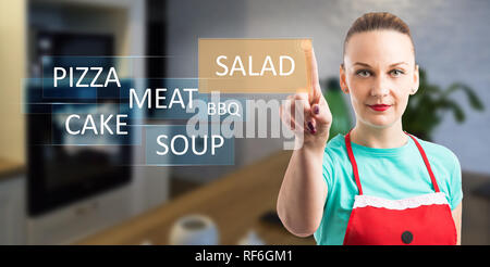 Woman choosing salad as food on invisible display by using index finger for touching as cooking and eating concept Stock Photo