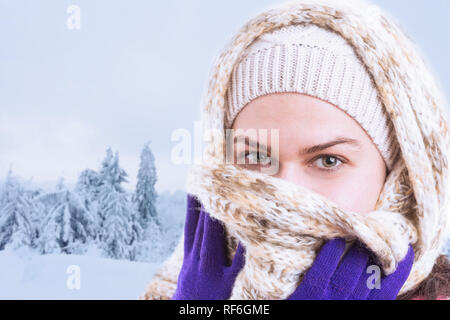 Close-up of young woman covering mouth and nose with beige scarf held with purple gloves as winter clothing and accessories concept