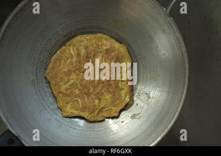 close up omelet thai food in a frying pan . Thai food Stock Photo
