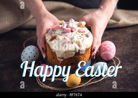 Traditional Easter cakes and colorful eggs and text on a dark background. Concept holiday card Stock Photo