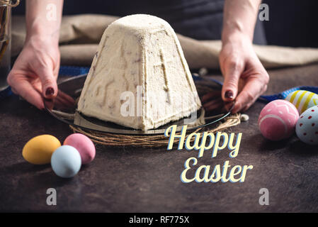 A card with traditional Easter cakes and colorful eggs and text on a dark background. Happy Easter Stock Photo