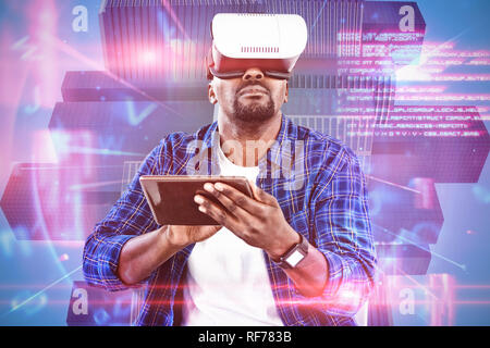 Composite image of man using virtual reality headset and digital tablet Stock Photo