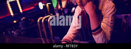 Female bartender using digital tablet while maintaining records at the counter Stock Photo