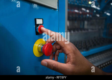 Hand pressing a red button Stock Photo