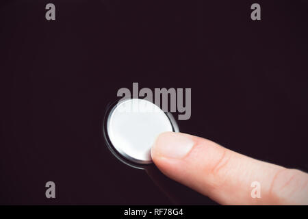 Finger pressing a button Stock Photo