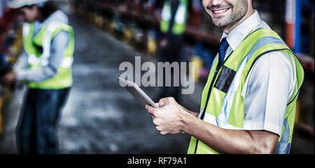 Worker in warehouse looking at camera Stock Photo