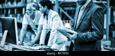 Warehouse managers and worker working together Stock Photo
