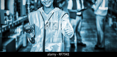 Smiling female worker with thumb up Stock Photo