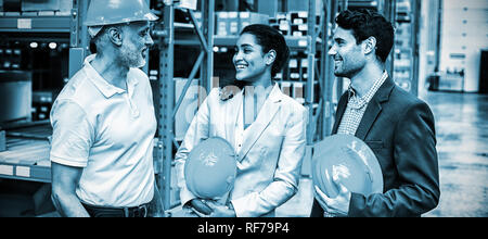 Happy warehouse managers and worker standing together Stock Photo