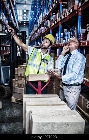 Businessman and warehouse worker Stock Photo