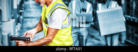 Worker is working on cardboard boxes with his colleagues Stock Photo