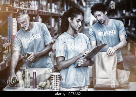 Volunteers working in a warehouse Stock Photo