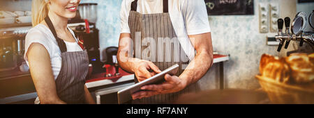 Happy co-workers using digital tablet Stock Photo
