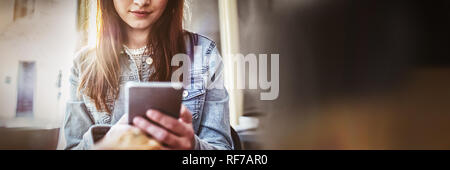 Beautiful woman using smartphone at coffee shop Stock Photo