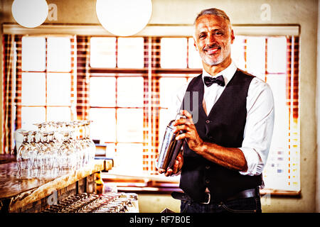 Bartender mixing a cocktail drink in cocktail shaker Stock Photo