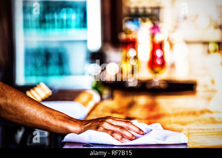 Waitress cleaning the counter in a restaurant Stock Photo