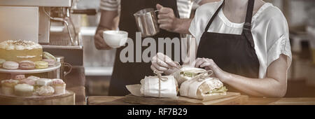 Waiter and waitress working behind the counter Stock Photo