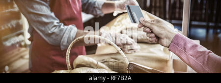 Hand giving credit card at payment counter Stock Photo