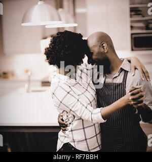 Romantic couple dancing in kitchen Stock Photo
