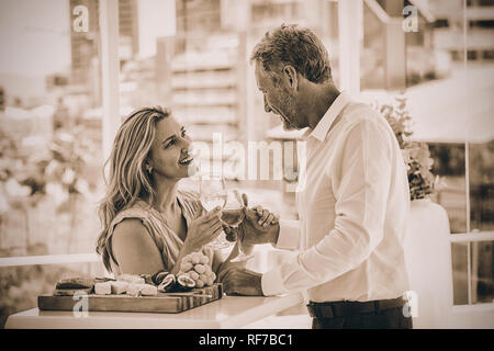 Smiling mature couple toasting white wine Stock Photo