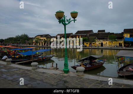 Boats tied up along the Thu Ban river in the Ancient Town section of Hoi An, Vietnam. Stock Photo