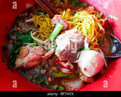 Special noodle spicy soup or noodles tom yum soup thai style with pork and other seasoning on table in local restaurant at Nonthaburi, Thailand Stock Photo