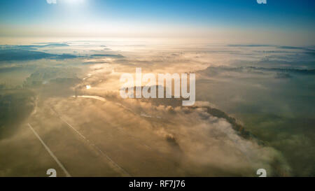 Aerial view of morning foggy sunrise and rural fields. Colorful autumn morning. Sunrise scene from above. Minsk region, Belarus. Stock Photo