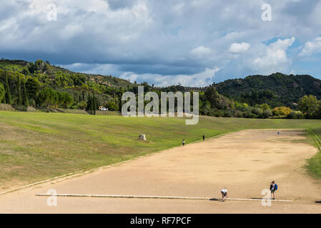 Olympia, Greece - October 31, 2017: Tourists visiting the ancient Olympia. Classic greek olympic stadium at Olympia in Greece. Stock Photo