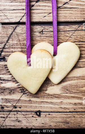 Heart shaped cookies for valentine's day on wooden background. Copy space. Stock Photo