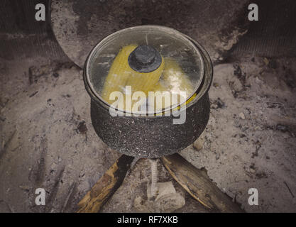 Boiled corns in the authentic pot. Authentic fireplace in the village. Stock Photo