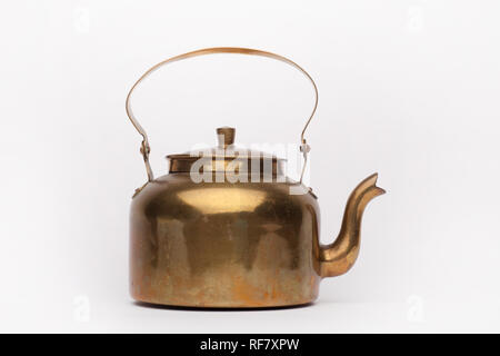 Miniature antique brass teapot isolated on white background Stock