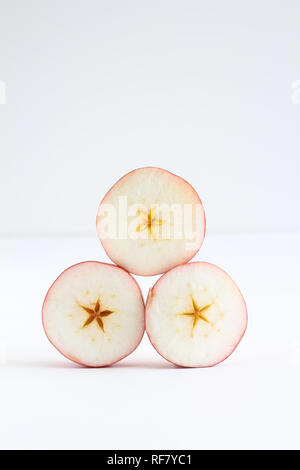 Stacked sliced pieces of apple on a white background Stock Photo