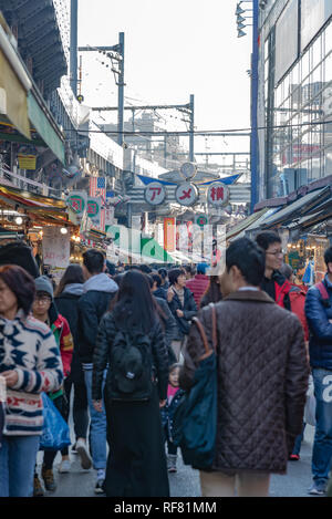 Ameyoko or Ameyayokocho market near Ueno station. One of main shopping street in Tokyo. Text advertise market name and vendor shops including watches Stock Photo