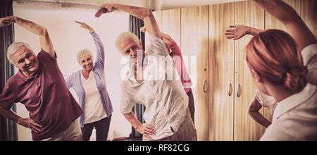 Group of seniors doing exercises with nurse Stock Photo