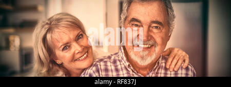 Senior couple hugging each other at home Stock Photo