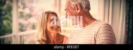 Happy senior couple interacting with each other in balcony Stock Photo