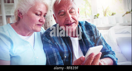 Senior couple using mobile phone Stock Photo