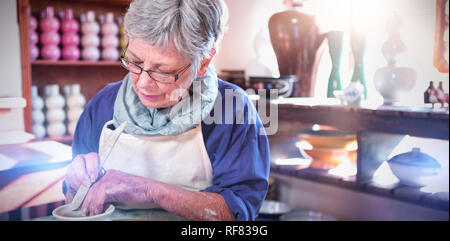 Female potter making pot Stock Photo