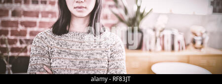 Portrait of confident beautiful young woman standing with arms crossed Stock Photo