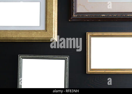 Blank empty frames on dark wooden background. Art gallery, museum exhibition white clipping path Stock Photo