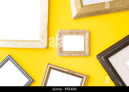 Blank empty golden, wooden frames on yellow background. Art gallery, museum exhibition white clipping path Stock Photo