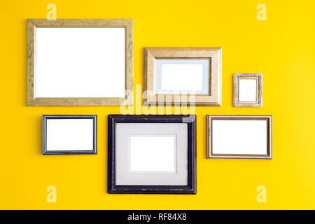 Blank empty golden, wooden frames on yellow background. Art gallery, museum exhibition white clipping path Stock Photo