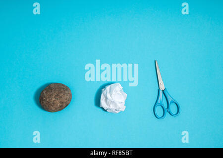 Rock, paper, scissors concept. Choice, decision making. Top above view on blue background Stock Photo