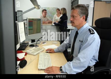 Police officers at the office, new blue police uniforms worn by 1400 male and female North Rhine-Westphalian police officers Stock Photo