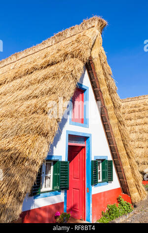 Palheiro house Santana Madeira Traditional triangular A-framed Palheiro Houses Santana Madeira Portugal red blue and white painted house portuguese Stock Photo