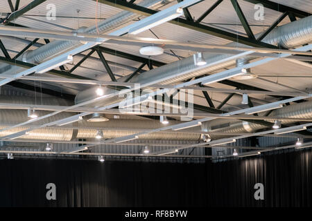 Factory building or warehouse building. Vast empty space with ventilation pipes and lights Stock Photo