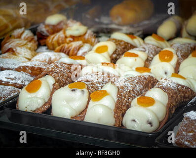 Sicilian cannoli and cakes in shop window of Italian cafe Stock Photo