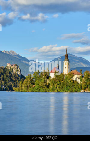 Church Of The Assumption on Blejski Otok with Bled Castle, Lake Bled, Bled, Gorenjska, Slovenia Stock Photo
